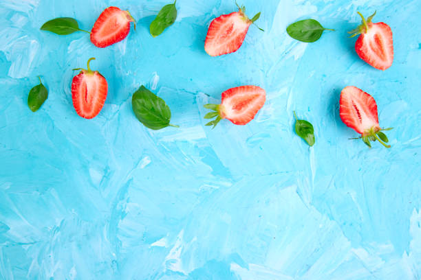 istock Strawberry and basil on blue background. Flat lay 1076531988