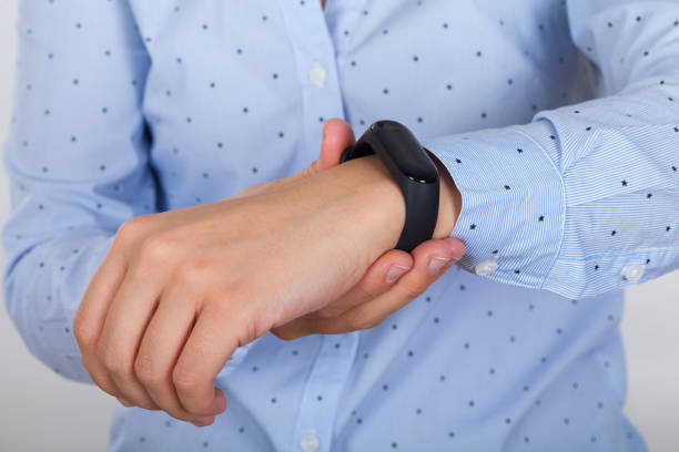 istock Mi fit band on female wrist 1076535656