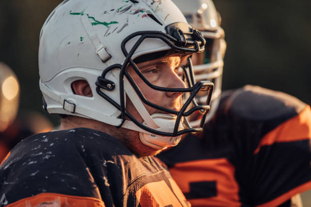 istock Football player with helmet 1076558830