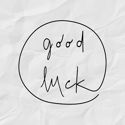 Good luck hand drawn lettering. Inspirational quote on white crumpled paper.