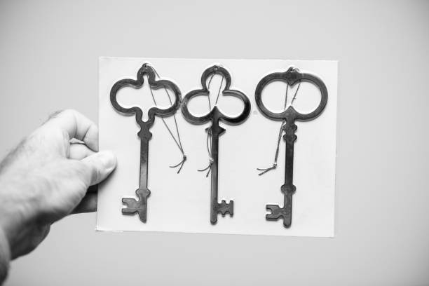 Man holding three new golden keys white background