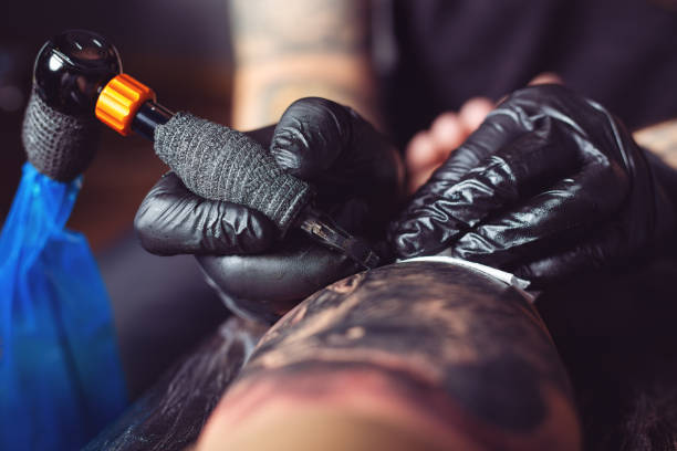 istock Artist tattooing man's arm 1076573208