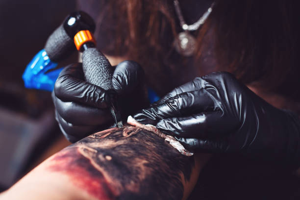 istock Artist tattooing man's arm 1076574746