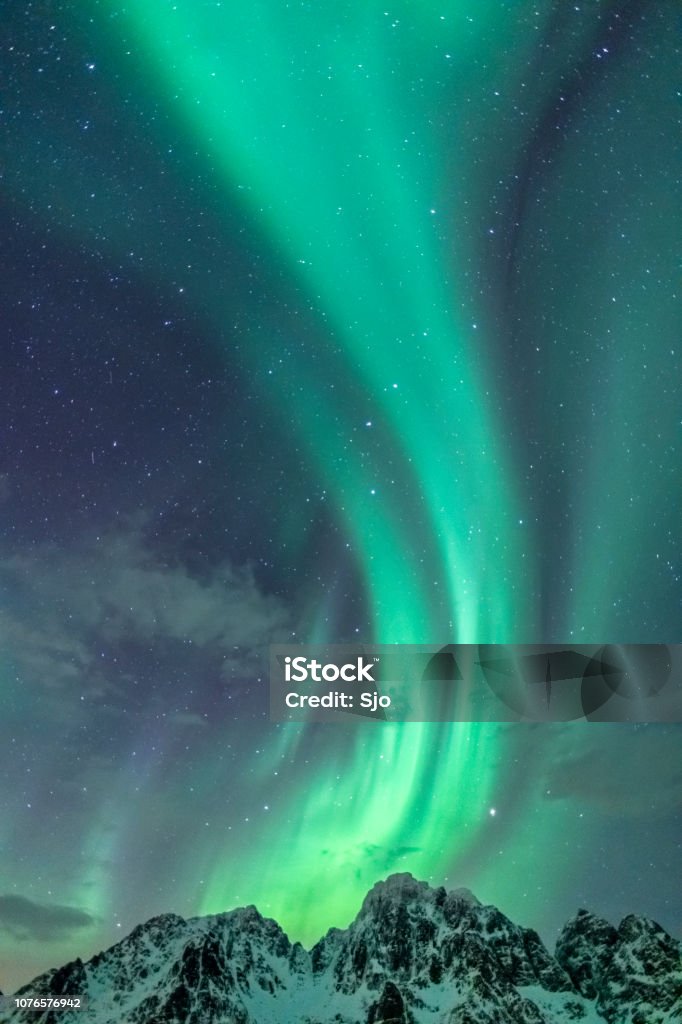 Northern Lights background image with mountain peaks and Aurora Northern Lights background image with only sky and Aurora Borealis in the starry night over the Lofoten in Northern Norway. Aurora Borealis Stock Photo