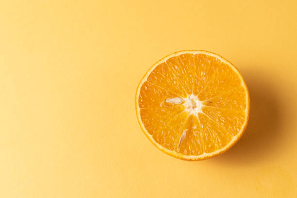 istock ripe mandarin or tangerine fruit over yellow background. 1076578068