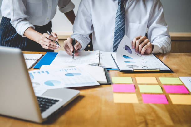 istock Co working conference, Business team colleagues discussing working analysis with financial data and marketing growth report graph in team, Meeting Talking Brainstorming Communication Concept 1076579248