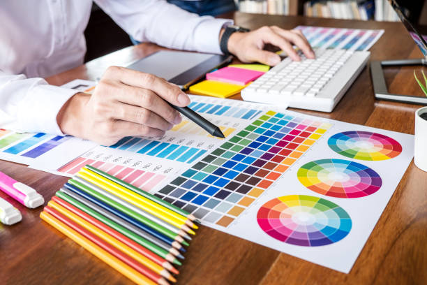 istock Image of male creative graphic designer working on color selection and drawing on graphics tablet at workplace with work tools and accessories 1076579274