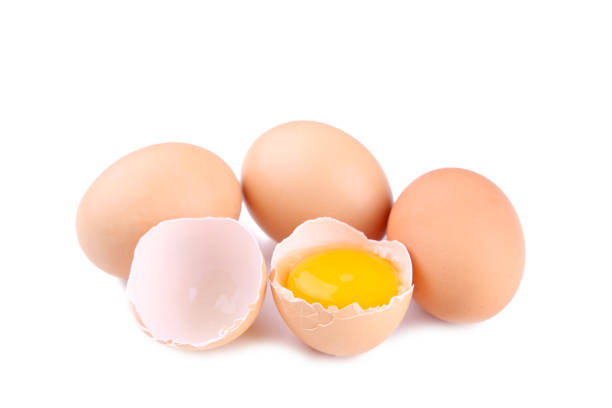 istock Chicken eggs and half with yolk on a white background. 1076585032