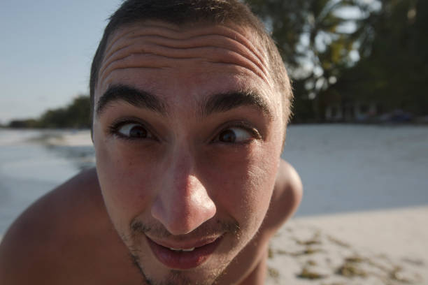 istock Young Playful Man Making a Face and Looking at Camera 1076588220