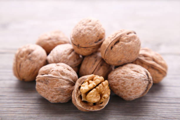 istock Walnuts kernels on grey wooden background. Walnut healthy food 1076588912