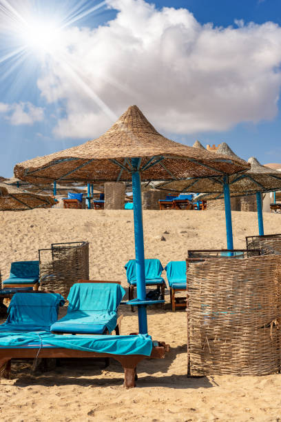 istock Straw Beach Umbrellas and Deck Chairs - Red Sea Egypt 1076589448