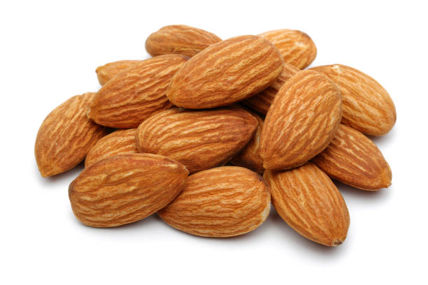 Group of almonds isolated on white background. Macro, studio shot.