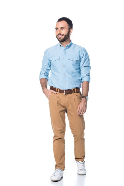 istock smiling bearded man with hand in pocket isolated on white 1076595512