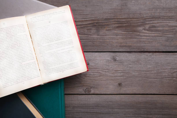 istock Old vintage books on grey wooden table 1076595846