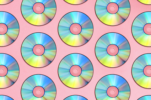 Compact discs on a pink background