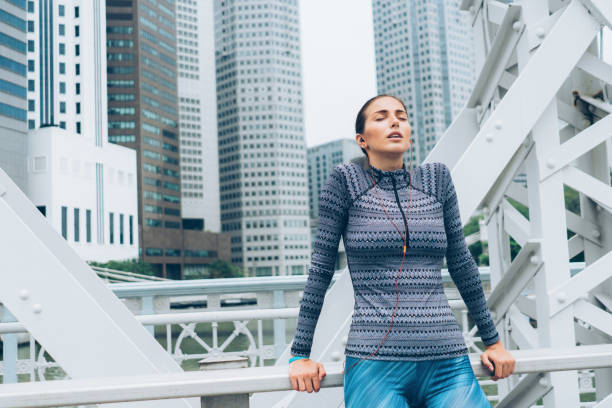 istock Exhausted sportswoman taking breath 1076596704