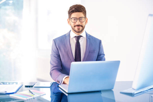 istock Young business person sitting behind notebook in the office 1076603380