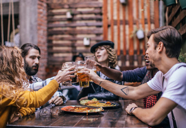 istock Friends drinking beer in pub outdoors 1076603668