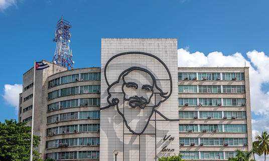 Havana, Cuba. 22nd November 2018. The large 'Monumento Camilo Cienfuegos' on the side of a building in Havana, Cuba. With a Cuban flag.