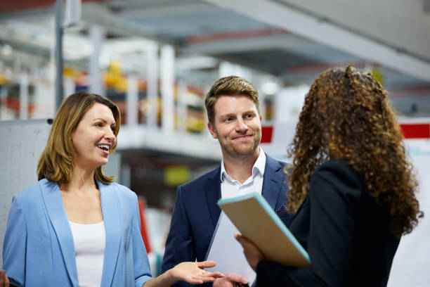 istock Smiling multi-ethnic team discussing at factory 1076608856