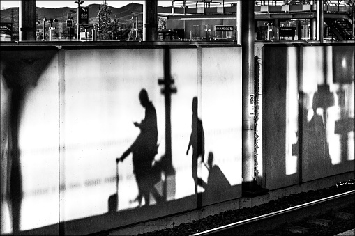 Passenger shadows on a station platform