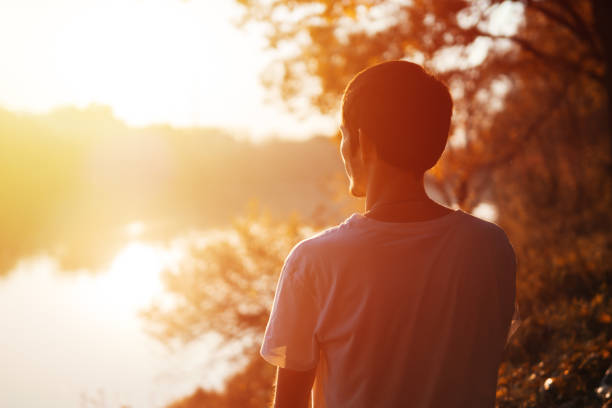 istock Young man enjoying the sunset sun 1076613206
