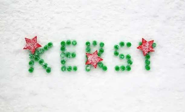 snowy background, green color and red stars. With top-view perspective and text space