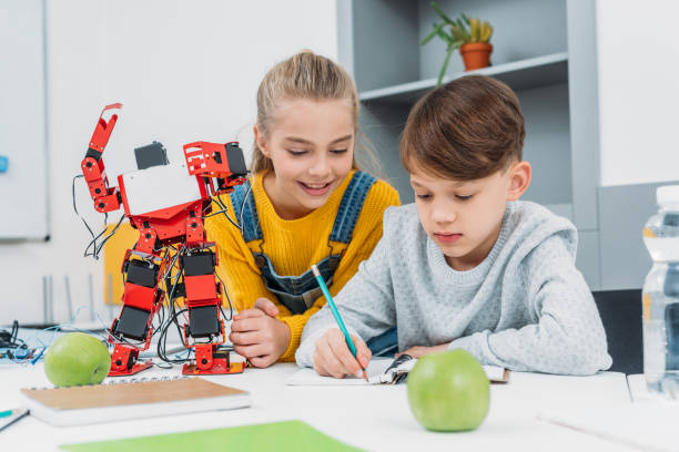 istock schoolchildren writing in notebook at STEM robotics lesson 1076614148