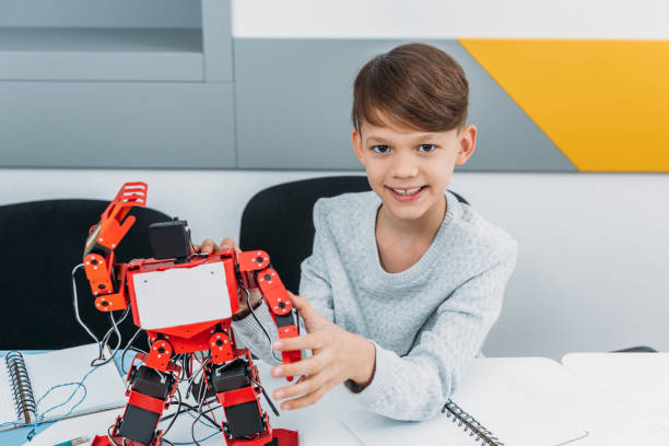 istock schoolboy working with robot at STEM robotics lesson 1076614200