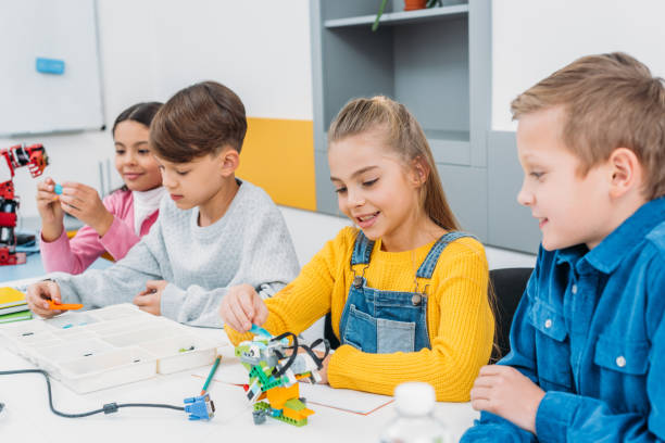 istock schoolchildren making electric robot at desk in stem education class 1076614274