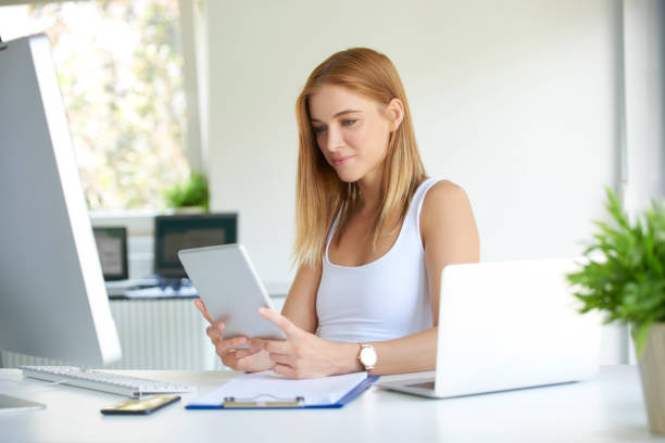 istock Sales woman holding touchpad in her hand 1076614664