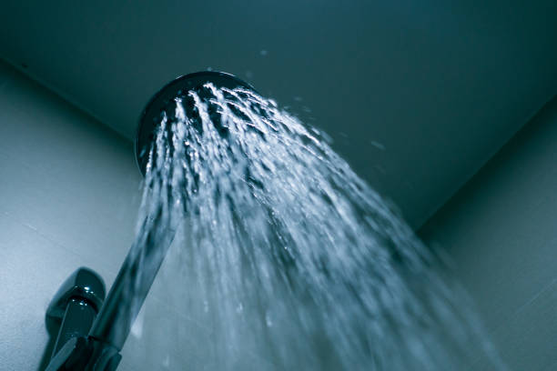 istock Shower head with drops of water falling 1076621912