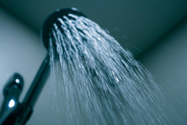 istock Shower head with drops of water falling 1076622026