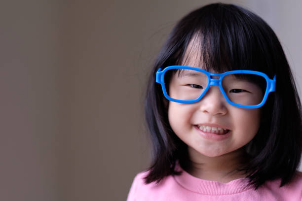istock Funny little child with big blue glasses 1076626142