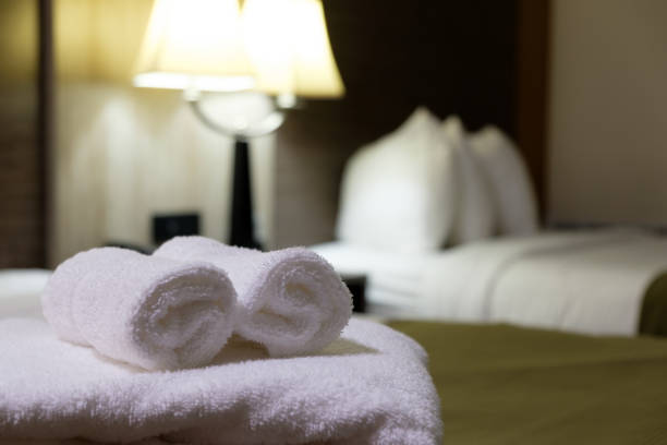 White bath towel on bed in hotel room White towel on bed in guest room for hotel customer. guest bathroom stock pictures, royalty-free photos & images