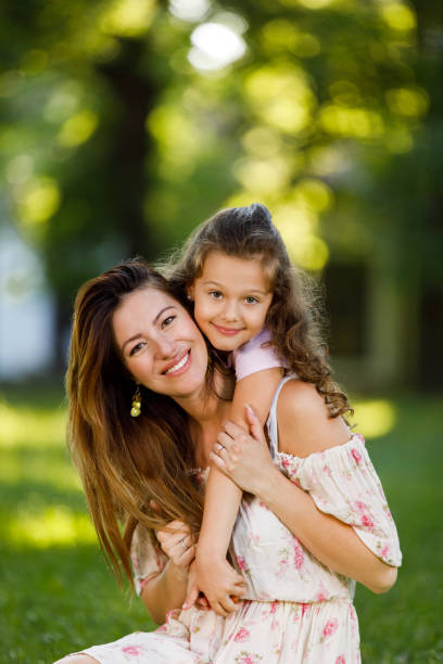 istock Mother and daughter outdoors playing and hugging 1076626768