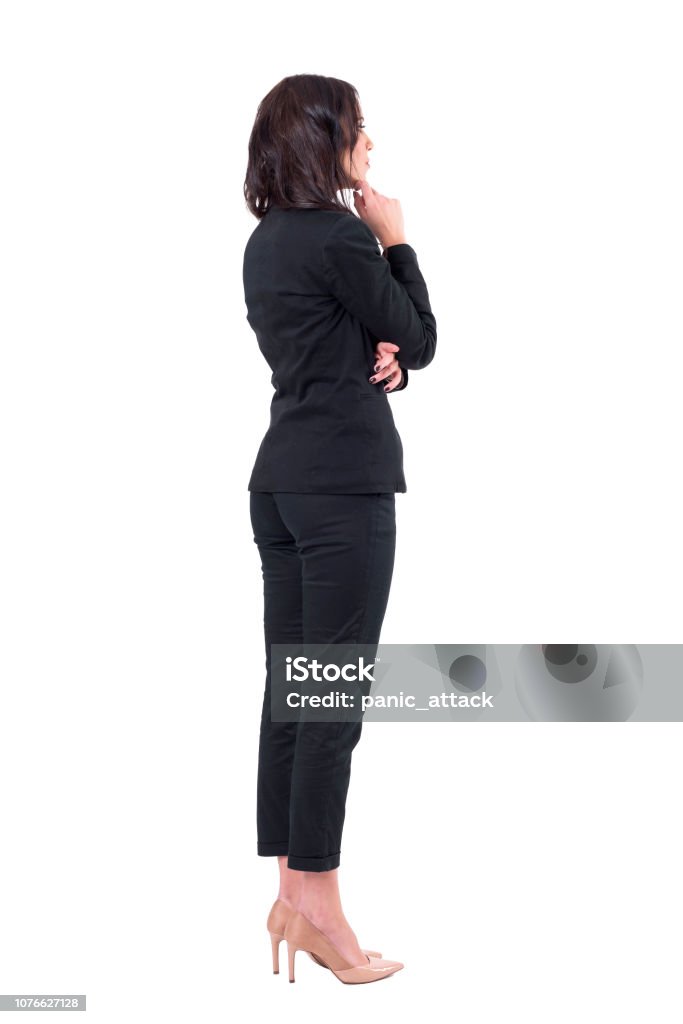 Back view of elegant business woman in suit looking away at something watching interested Back view of elegant business woman in suit looking away at something watching interested. Full body isolated on white background. Rear View Stock Photo