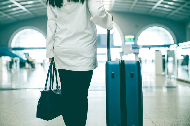 istock Traveler with suitcase in airport 1076627252