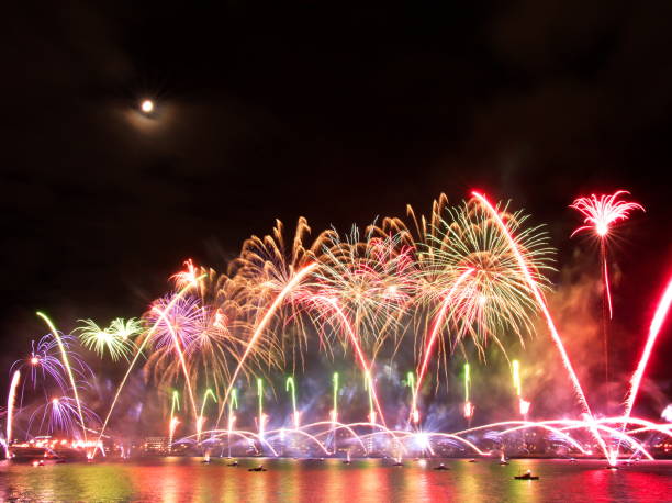 istock Gorgeous multi-colored light show and fireworks display on dark night sky over the river Daugava 1076628126