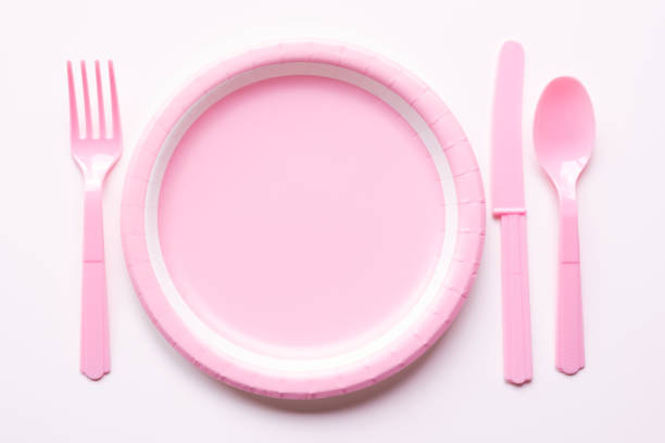 istock Pink color paper plate with plastic spoon, fork and knife 1076650384