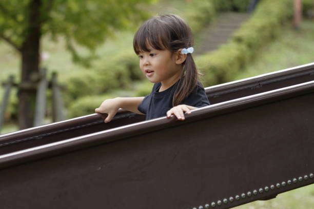 istock Japanese girl on the slide (3 years old) 1076650954