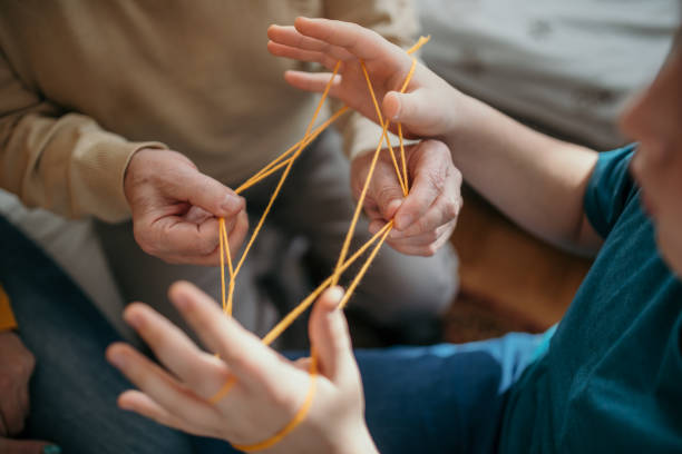 Family playing cats cradle