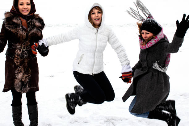 Winter joy in nature with smiling woman in green coat.