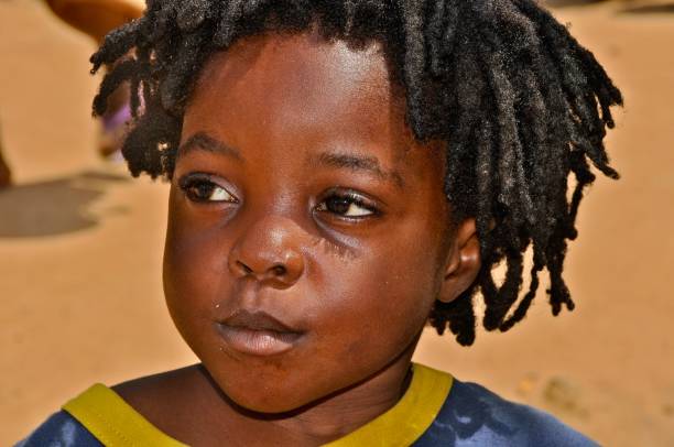 istock Close-Up Of Cute Boy Looking Away 1076659188