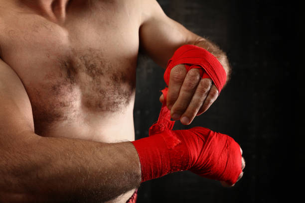 istock Midsection Of Shirtless Boxer Standing Against Black Background 1076662322