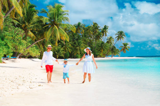 istock happy family with kid playing on beach 1076664976