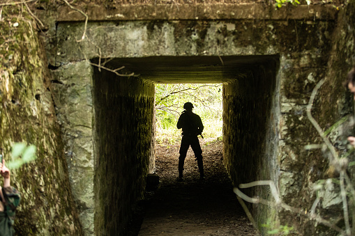 Military man standing in the tunnel alone