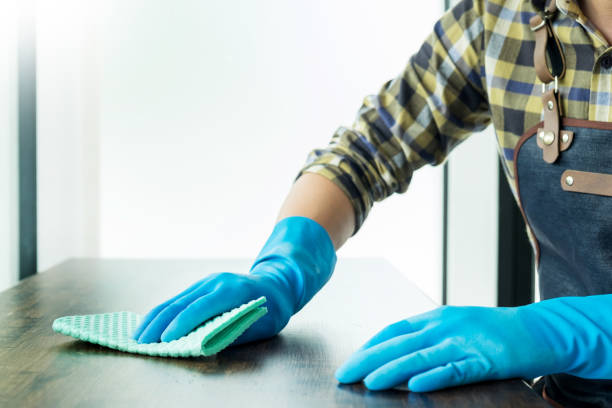 istock Midsection Of Man Cleaning Table With Sponge 1076665620