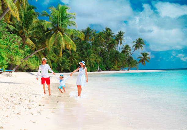 istock happy family with kid playing on beach 1076666816
