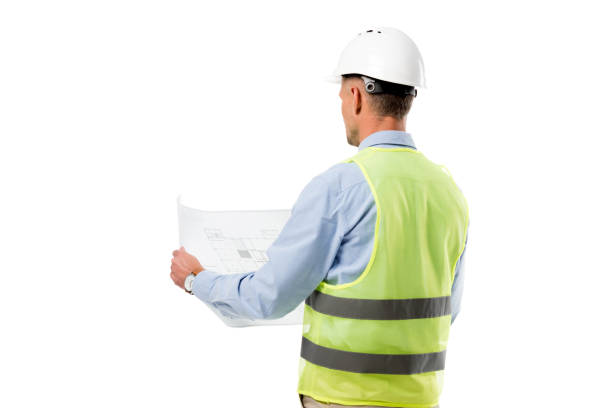 istock back view of engineer in helmet holding blueprint isolated on white 1076666884